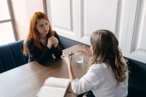 Two people talking about addiction therapy program options near Denver in Colorado