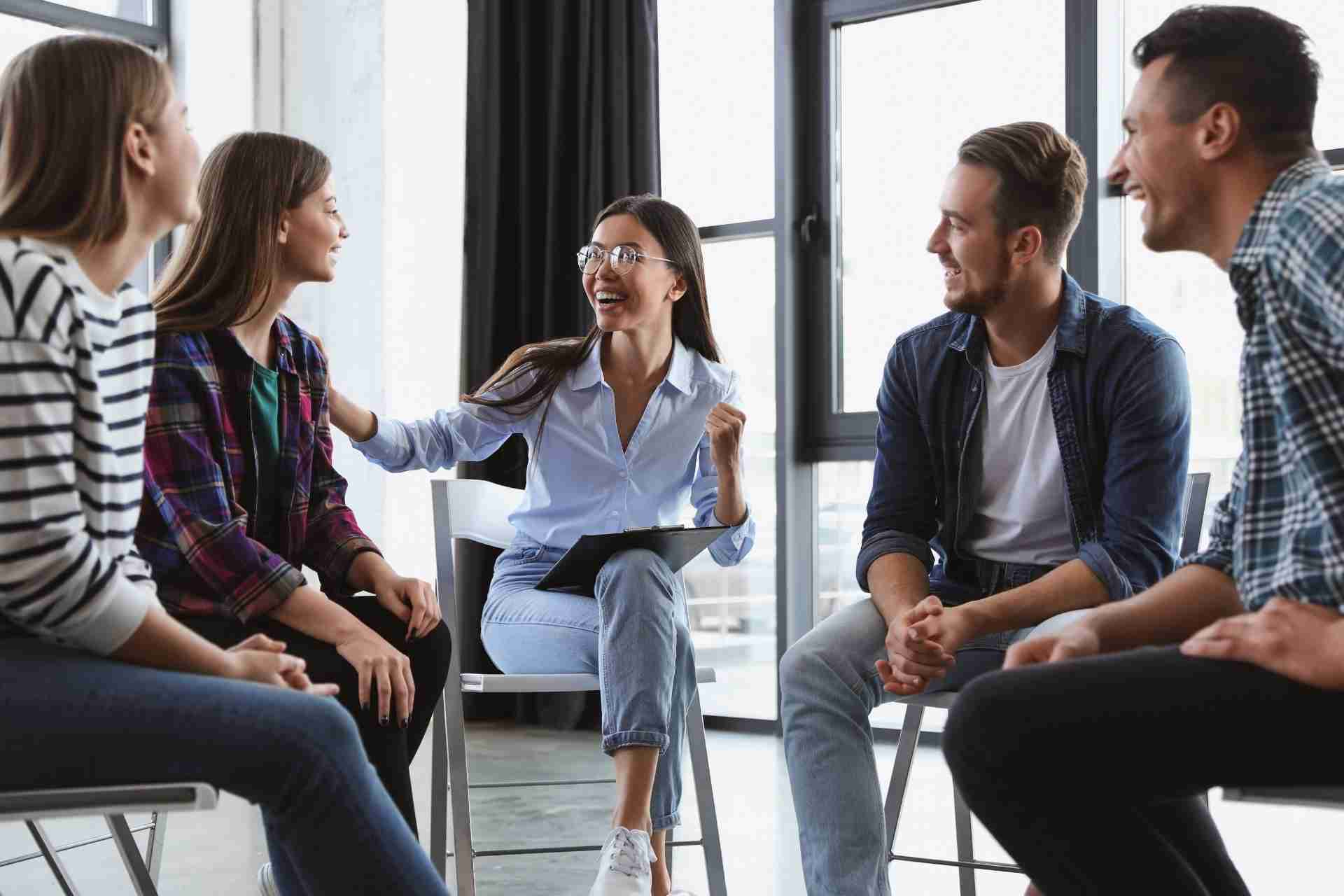 Individuals participating in a group therapy session for substance abuse recovery